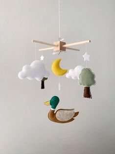 a mobile with birds and clouds hanging from it