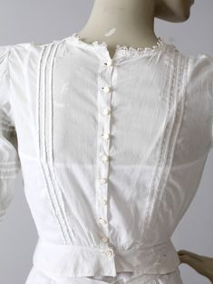 An Edwardian era blouse. The small white cotton blouse features intricate white embroidery. Sweet little buttons closes the blouse down the back. There is lace trim at neck, pin tuck detailing, and three-quarter sleeves. CONDITION In good antique condition. There is a worn spot on back of waistband. Holes do not go all the way through. There is some thinning and wear to the left shoulder. SIZE & MEASUREMENTS Approximate SizeXS Bust32 inch ...81.3 cm Length13.5 inch ... 34.3 cm Shoulders15.5 Edwardian Blouse, White Cotton Top, Pucci Dress, Tuck Dress, Hippie Boots, White Cotton Blouse, Dress Layered, Vintage Clothing Online, Suspender Dress