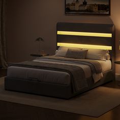 a bed that has some lights on the headboard and night stands in front of it