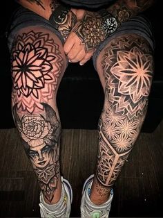 a person with tattoos on their legs sitting down