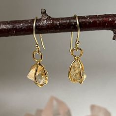 Citrine Raw In Cage Earrings The hooks are sterling silver gold plated  Light and easy to wear   Citrine is the clear yellow or golden form of the mineral quartz. It is said to assist in creating prosperity, and is a stone of joy, openness and optimism. Take care to avoid extreme humidity or heat as this may cause tarnishing. Your gold vermeil and silver jewellery should be kept in a dark, cool and dry place. Substances like oil, nail polish remover, chlorine and perfume may react with metal/pla Cage Earrings, Dark Cool, Orange Citrine, Heavy Work, Polish Remover, Luck Charms, Nail Polish Remover, Silver Jewellery, Gold Plated Jewelry