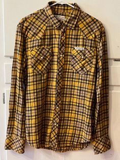 Vintage True Religion brand jeans Flannel, long sleeve button up, styled in California, size large. Yellow blue and black plaid. Pearl buttons down the front, pockets, and cuffs. Very Soft. Horseshoe stitching on the pockets. 21.5" flat P2P (up to 43" Chest). In excellent condition. Free Shipping Plaid Long Sleeve Western Flannel Shirt, Western Style Long Sleeve Plaid Flannel Shirt, Fitted Long Sleeve Flannel Shirt, Casual Yellow Button-up Flannel Shirt, Yellow Fitted Shirt For Fall, Fitted Yellow Shirt For Fall, Yellow Shirt With Button Closure For Fall, Yellow Long Sleeve Flannel Shirt For Fall, Jean Vintage