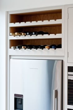 a refrigerator with many magnets on it in a kitchen