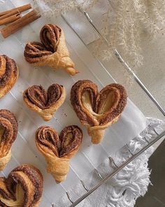 cinnamon rolls on a tray with cinnamon sticks in the middle and cinnamon sticks sticking out of them