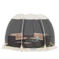 an outdoor tent with furniture inside it