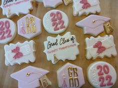 decorated cookies are arranged on a table for graduation