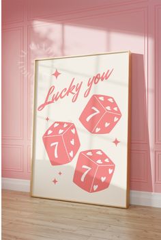 a poster with the words lucky you and three dices on it in front of a pink wall