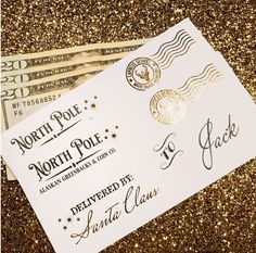 two tickets are sitting next to each other on some gold glittered paper with the words north pole written on it