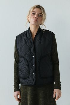 The Anouk Vest is pure comfort and warmth. This quilted vest features a snap front closure and roomy front pockets. The textile is lined with warm and cozy sherpa fleece. Cut roomy for all kinds of layering possibilities. Oversized fit. Model is wearing X SMALL. Model is 5'8". Please review our size guide prior to ordering. Need specific measurements? Send us an email and we will be happy to help you find the perfect fit. Hooded Vest Outfit, Vest Outfit, Hooded Vest, Quilted Vest, Sherpa Fleece, Pull On Pants, Black Media, Oversized Fits, Warm And Cozy