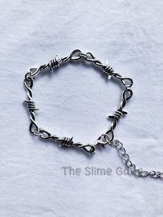 Silver Barbed Wire Steel Plated Silver Bracelet Available in 2 sizes (6" and 7") It does come with a chain on the end so you can make it bigger if you like. The one in the picture is 7" If none of those sizes are ok I can custom it to other sizes possibly just drop me a message. Any questions at all just drop me a message. Emo Y2k, Rock Tattoo, Barbed Wire, Wire Bracelet, Wedding Jewellery Necklace, Wedding Necklace, Wedding Jewelry, Silver Bracelet, Bracelet