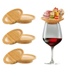 three wine glasses with wooden trays and one glass filled with red wine on the side