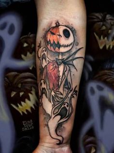 a person with a halloween themed tattoo on their arm