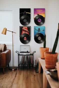 there are three records on the wall in this living room, and one has a record player