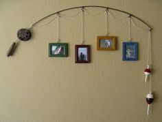 a wall with pictures hanging from it's sides and a clock on the side