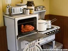 a turkey is cooking in an oven with other food items on the counter and around it