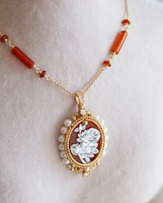 Beautiful statement piece with two-layer red Agate Cameo pendant in 14K gold filled wires with freshwater Pearls. The pendant carefully attached on handmade chain with red agate beads, finished with a lobster clasp and extension. High quality Agate Cameo has two-layer design that is beautifully detailed flowers that carved from shell. Very detail work and good quality stones. The pictures do not do this necklace justice!! All jewellery in Artisan Made collection is unique and only one piece avai Red Cameo Oval Jewelry, Red Cameo Jewelry Gift, Red Cameo Jewelry For Wedding, Carnelian Cameo Jewelry Gift, Cameo Carnelian Jewelry Gift, Red Cameo Necklace For Gift, Cameo Pendant Necklace, Handmade Chain, Cameo Pendant