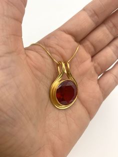 Gold Ruby Pendant set with a Created Ruby in a flawless diamond cut & bright red color, at 18mm (20 Carats).Gold Vermeil: 18k Gold over Solid 925 Sterling Silver ☞ made to last.Click here for ☞ Statement Jewelry CollectionMatching Ring & Earrings ☞ please ask meDetails:• Created Ruby in a flawless clarity• Ruby: 18mm, 20 Cts, diamond• Dimensions: Pendant Height 32mm, Width 22mm• Free Complimentary Chain• 18k Gold VermeilSKU 1246 Elegant Ruby Necklace With Round Stone, Ruby Round Pendant Necklace In Yellow Gold, Yellow Gold Ruby Round Pendant Necklace, Yellow Gold Ruby Round Pendant Jewelry, Ruby Round Pendant With Polished Finish, Ruby Necklace Designs, Ruby Diamond Pendant, Gold Jewellry, Flawless Diamond