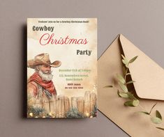 a cowboy christmas party card next to an envelope on a gray background with greenery