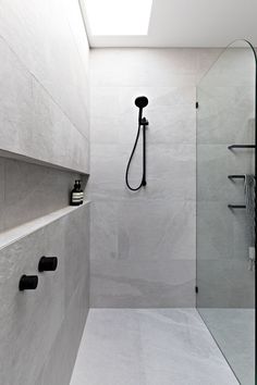 a walk in shower sitting under a skylight