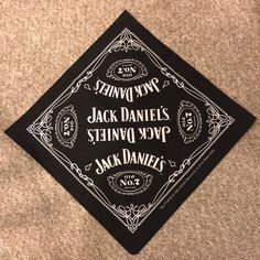 a black and white graduation cap with the words jack daniels, stencil typo, and mark daniels on it