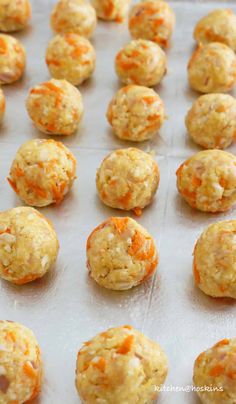 carrot and cheese balls on a baking sheet ready to go into the oven for cooking