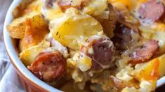 a close up of a bowl of food with sausage and potatoes