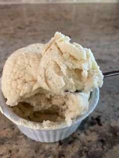 a bowl filled with ice cream on top of a counter