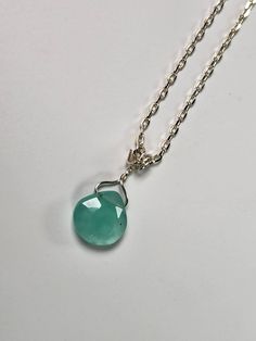 This Chalcedony Gemstone Pendant is amazing! The facets shine from every angle. The color is amazing! It lays nicely and is very dainty. The Gem is a bit over 10mm in size and has stunning color!! This stone has calming and stabilizing energy which helps increase the mental abilities, inner peace, and emotional honesty. It is a solid healing stone as well, protecting against infections and various health conditions. Chalcedony shields against negative outside influences that may lead to nightmare dreams. This stone opens a channel for better communication and helps verbalize our feelings the proper way. It increases life energy and promotes emotional balance, vitality, and fortitude. It makes us generous, kind, and friendly, always ready to perform good deeds. Silver Faceted Round Pendant Jewelry, Sterling Silver Crystal Necklaces For May Birthstone, Sterling Silver Crystal Necklace For May Birthstone, Faceted Sterling Silver Round Pendant Jewelry, Sterling Silver Faceted Round Pendant Jewelry, Sterling Silver Crystal Necklace With Faceted Beads For Gift, Silver Faceted Briolette Crystal Necklace, Silver Faceted Briolette Necklaces, Silver Faceted Teardrop Pendant Jewelry