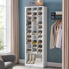 a white shoe rack filled with shoes in a living room next to a chair and window