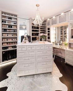 a large closet with lots of shoes and purses on top of the dresser in front of it