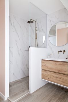 a bathroom with marble and wood accents