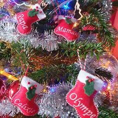 a christmas tree with stockings hanging from it