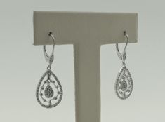 Stunning vintage handmade 14K solid white gold round cut natural diamonds dangle drop earrings. Meira T designer. These gorgeous earrings are in excellent condition and a great gift for someone you love. Drop length approx: 23.8 mm Earring length approx: 32.3 mm Earring width: 12.4 mm Total diamond weight approx: 0.59 ct Earrings weigh approx: 3.4g Hallmark: 14K, Meira T Will be placed into a suitable gift box Free shipping within the U.S. Larchmont Ny, Vintage 2000s, Gorgeous Earrings, Round Cut Diamond, Round Cut, Natural Diamonds, Dangle Drop Earrings, Great Gifts, Gift Box