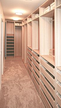 an empty walk in closet with lots of drawers