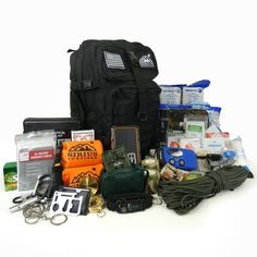 the contents of a backpack and other items are laid out in front of each other