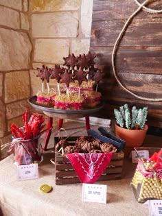 desserts and candies are displayed on the table for guests to sit down at