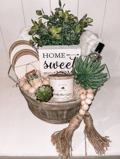 a potted plant sitting on top of a table next to a sign that says home sweet