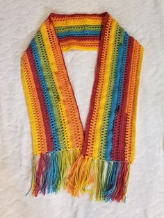 Handmade 69" Long Rainbow Crocheted Scarf. It is 69" long not including the fringe at the end. My Mom (who is legally blind) made this scarf. It is brand new. She has Crocheted my whole life. It's a tradition passed down in my family. SHE IS LITERALLY AMAZING AT IT!!! She doesn't believe that she is "that good". So I had her make a BEAUTIFUL rainbow scarf just so I could prove that people would buy the AMAZING stuff she makes for fun. Rainbow Scarf Crochet, Crocheted Scarf, Gold Scarf, Rainbow Scarf, Rainbow Crochet, The Fringe, My Whole Life, Beautiful Rainbow, Crochet Scarves