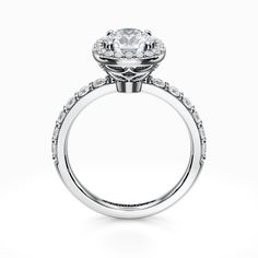 a white gold engagement ring with an oval diamond center