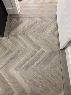 an overhead view of a kitchen with wood flooring and white cabinets in the background