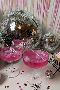 pink cocktails and disco balls on a table