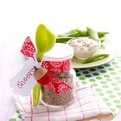 a jar filled with food sitting on top of a table next to green beans and broccoli