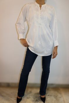 Step into effortless sophistication with our Timeless Elegance Linen Blouse. Crafted from the softest white linen, this blouse features exquisite vintage chikankari embroidery that whispers tales of heritage. The buttoned yoke, accentuated with delicate shoulder panels, adds a touch of classic charm. Cuffed poet sleeves complete the look, offering a flowy and romantic silhouette. Key Highlights: Soft white linen for ultimate comfort Vintage chikankari embroidery for a timeless touch Buttoned yoke with stylish shoulder panels Cuffed poet sleeves for a romantic flair Perfect for breezy summer days or elegant evenings, this blouse effortlessly blends tradition with modern style. Length - 29-30 inches Sizes -  S - fits bust 34 M - fits bust 36 L - fits bust 38 XL - fits bust 40 0X - fits bust Spring Linen Top With Chikankari Embroidery, Elegant Linen Tops With Floral Embroidery, Elegant Summer Top With Chikankari Embroidery, Elegant Summer Chikankari Embroidered Top, Elegant Chikankari Embroidered Top For Summer, Long Sleeve Broderie Anglaise Blouse In Relaxed Fit, Long Sleeve Broderie Anglaise Blouse With Relaxed Fit, Long Sleeve Blouse With Broderie Anglaise In Relaxed Fit, Linen Blouse With Floral Embroidery