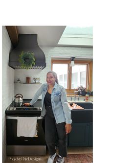 a woman standing in front of a stove top oven next to a sink and counter