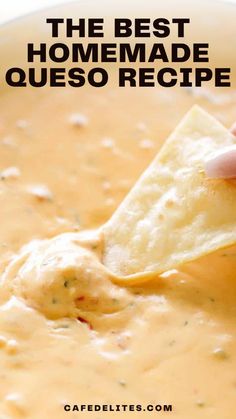 a tortilla chip being dipped into a bowl of quesadilla soup