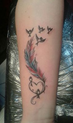 a woman's arm with birds flying around it and a heart shaped feather tattoo