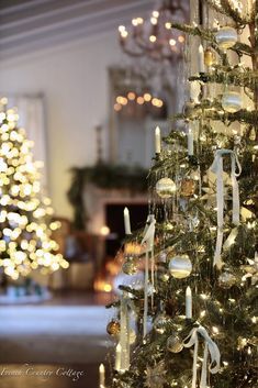 a christmas tree decorated with white and gold ornaments