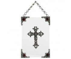 a cross hanging from a chain on a white wall in front of a white background