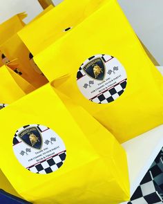 yellow paper bags with black and white checkerboard design on the front are sitting on a table