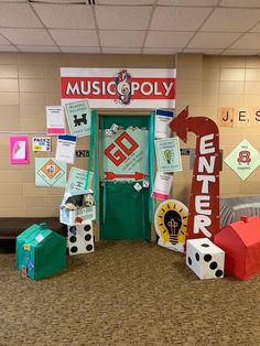 an entrance to a music school decorated with dices and paper machines on the floor